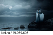Young elven girl with sword on sea coast. Стоковое фото, агентство Ingram Publishing / Фотобанк Лори