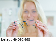 Woman holding spectacles. Стоковое фото, агентство Ingram Publishing / Фотобанк Лори