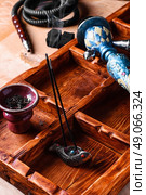 Accessories for Shisha. Dismantled parts of hookah on wooden background . Стоковое фото, агентство Ingram Publishing / Фотобанк Лори