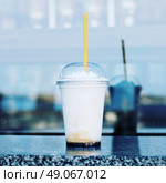 Vanilla frappe with plastic straw. Стоковое фото, агентство Ingram Publishing / Фотобанк Лори