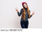 Beauty portrait of a young beautiful girl with long ombre straight hair wearing marsala color warm hat. Magnificent hair. Lips care. Young blonde hipster girl having fun. Стоковое фото, агентство Ingram Publishing / Фотобанк Лори