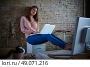 Businesswoman casual sitting at office working with laptop computer feet on table relaxed. Стоковое фото, агентство Ingram Publishing / Фотобанк Лори
