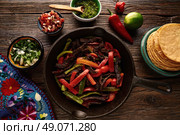 Beef fajitas in a pan with sauces chili and sides Mexican food. Стоковое фото, агентство Ingram Publishing / Фотобанк Лори