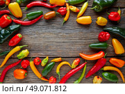 Mexican hot chili peppers colorful mix habanero poblano serrano jalapeno on wood. Стоковое фото, агентство Ingram Publishing / Фотобанк Лори