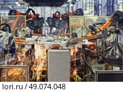 robots welding in a car factory. Стоковое фото, агентство Ingram Publishing / Фотобанк Лори