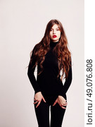 Beautiful girl with long wavy healthy hair. Brunette with curly hairstyle, and professional makeup, red lips. Стоковое фото, агентство Ingram Publishing / Фотобанк Лори