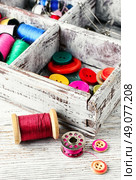 Thread and buttons with beads sewing and needlework. Buttons and spool of thread. Стоковое фото, агентство Ingram Publishing / Фотобанк Лори