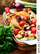 Dish with baked chicken potato with fresh vegetables.Photo tinted. Chicken with potatoes and vegetables. Стоковое фото, агентство Ingram Publishing / Фотобанк Лори
