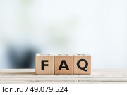 FAQ sign made of wood on an office table. Стоковое фото, агентство Ingram Publishing / Фотобанк Лори