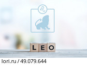 Leo star sign on a wooden table. Стоковое фото, агентство Ingram Publishing / Фотобанк Лори
