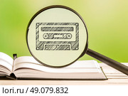 80s music information with a pencil drawing of a cassette tape in a magnifying glass. Стоковое фото, агентство Ingram Publishing / Фотобанк Лори