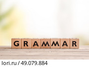 Grammar sign made of wood on a school desk. Стоковое фото, агентство Ingram Publishing / Фотобанк Лори