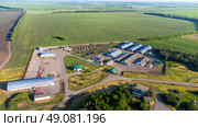 A farm with a lot of buildings and a lot of green grass. Стоковое фото, фотограф Скрипачев Антон / Фотобанк Лори