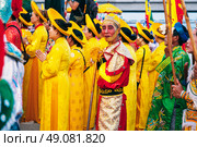 A Vietnamese man in colorful Cham costumes near the towers of Po Nagar in Nha Trang at a celebration. NHA Trang, Vietnam - April 17th, 2025. Редакционное фото, фотограф Корчагина Анастасия / Фотобанк Лори