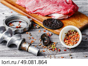 Raw beef on chopping board and kitchen utensils. Cooking meat dish. Стоковое фото, агентство Ingram Publishing / Фотобанк Лори