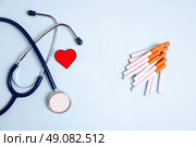 Stethoscope and cigarettes on blue background Health care concept. Стоковое фото, фотограф Марина Шеина / Фотобанк Лори