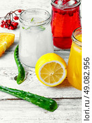 Freshly squeezed orange juice and citrus fruit in stylish glass jars. refreshing juice from fruits and aloe. Стоковое фото, агентство Ingram Publishing / Фотобанк Лори