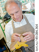cobbler mending heel of shoe. Стоковое фото, агентство Ingram Publishing / Фотобанк Лори