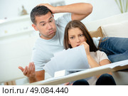 Worried couple looking at bills. Стоковое фото, агентство Ingram Publishing / Фотобанк Лори