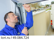 Fixing a damaged door. Стоковое фото, агентство Ingram Publishing / Фотобанк Лори