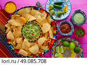 Nachos with guacamole tortilla chips in sombrero plate and sauces. Стоковое фото, агентство Ingram Publishing / Фотобанк Лори