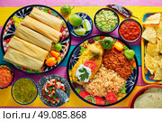 Tamale with corn leaf and filled chili pepper poblano guacamole  sauces. Стоковое фото, агентство Ingram Publishing / Фотобанк Лори
