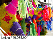 Mexican party pinatas decorated with fringed tissue colorful paper. Стоковое фото, агентство Ingram Publishing / Фотобанк Лори