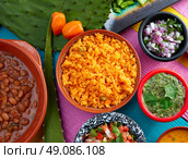 Mexican yellow rice with chilis and sauces frijoles beans. Стоковое фото, агентство Ingram Publishing / Фотобанк Лори