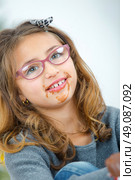 Little girl with chocolate around her mouth. Стоковое фото, агентство Ingram Publishing / Фотобанк Лори