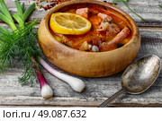 Dish of Russian cuisine-beef stew. Traditional Solyanka with smoked meats in wooden plate. Стоковое фото, агентство Ingram Publishing / Фотобанк Лори