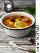 Dish of Russian cuisine-beef stew. Traditional solyanka with smoked meat products in the iron bowl. Стоковое фото, агентство Ingram Publishing / Фотобанк Лори