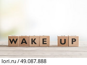 Wake up sign with wooden cubes on a table. Стоковое фото, агентство Ingram Publishing / Фотобанк Лори