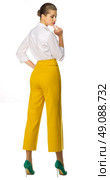 Young woman in yellow pants isolated. Стоковое фото, агентство Ingram Publishing / Фотобанк Лори