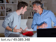 Two men screaming in excitement. Стоковое фото, агентство Ingram Publishing / Фотобанк Лори