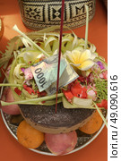 A plate of Hinduism offering consist of fruits, cake, flowers, incense and money. Стоковое фото, агентство Ingram Publishing / Фотобанк Лори