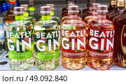 Beatly Gin в стеклянных бутылках на полке в супермаркете. Крепкие алкогольные напитки. Редакционное фото, фотограф FotograFF / Фотобанк Лори