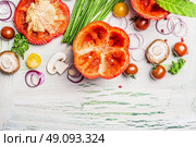 Red paprika with cutting  top , ready for stuffing and tasty cooking ingredients on white rustic wooden background, top view, border.  Vegetarian food and Healthy eating concept. Стоковое фото, агентство Ingram Publishing / Фотобанк Лори