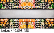 Varied Sushi sets assortment in bento boxes on gray stone background, top view, horizontal border or banner.  Japanese and Asian food. Стоковое фото, агентство Ingram Publishing / Фотобанк Лори