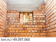 house under constraction with modern brick walls and holes for doors and windows. Стоковое фото, фотограф Feruza Tashmetova / Фотобанк Лори