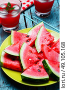 Cut slices of watermelon. Fresh fruit of summer watermelon cut into lobes on plate on bright background. Стоковое фото, агентство Ingram Publishing / Фотобанк Лори
