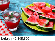 Cut slices of watermelon. Fresh fruit of summer watermelon cut into lobes on plate on bright background. Стоковое фото, агентство Ingram Publishing / Фотобанк Лори