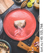 Summer rolls with canned tuna fish filling, making step by step on rustic kitchen table with plates, tolls and ingredients, top view. Стоковое фото, агентство Ingram Publishing / Фотобанк Лори
