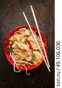 Asian noodles with chopstick, chicken and sprouts on dark wooden background, top view. Стоковое фото, агентство Ingram Publishing / Фотобанк Лори