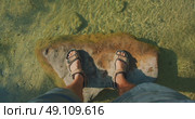 Man standing on large rock under clear shallow water of Cetina river in Croatia. Стоковое видео, видеограф Igor Tichonow / Фотобанк Лори