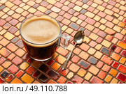 Coffee glass cup with cream on tiles red brown golden table. Стоковое фото, агентство Ingram Publishing / Фотобанк Лори