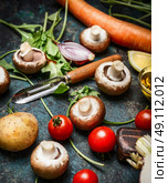 Fresh various vegetables ingredients  and vegetable peeler . Стоковое фото, агентство Ingram Publishing / Фотобанк Лори