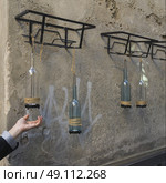 Decorative bottle lamps hanging on a wall, Orvieto, Terni Province, Umbria, Italy. Стоковое фото, агентство Ingram Publishing / Фотобанк Лори