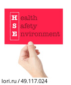 Health Safety Environment explained on a card held by a hand. Стоковое фото, агентство Ingram Publishing / Фотобанк Лори
