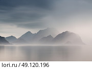 Summer cloudy Lofoten islands. Norway misty sea and fjords. Nordic rain. Стоковое фото, агентство Ingram Publishing / Фотобанк Лори