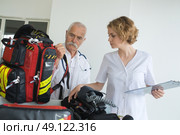 ambulance team preparing gear before intervention. Редакционное фото, агентство Ingram Publishing / Фотобанк Лори